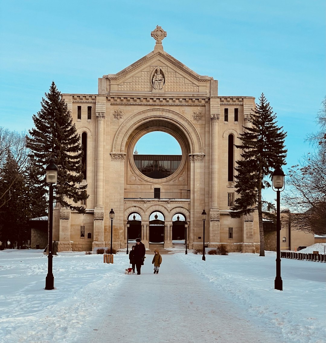 Historic stone architecture and a snowy path in Winnipeg