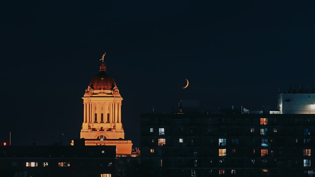 Winnipeg skyline at night with the illuminated Manitoba Legislative Building